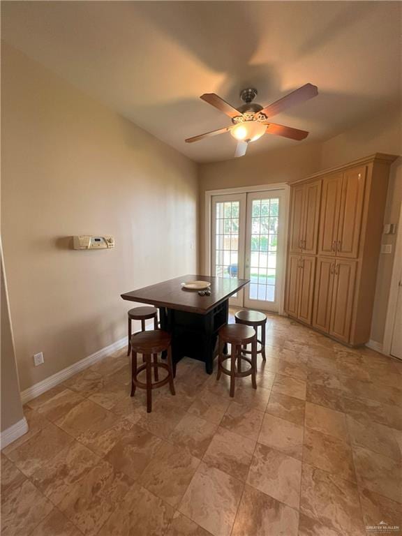 dining space with french doors and ceiling fan