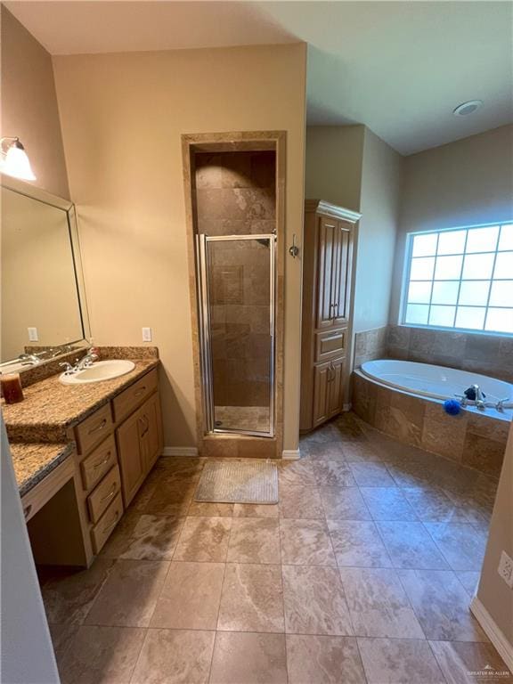 bathroom featuring tile patterned flooring, vanity, and shower with separate bathtub