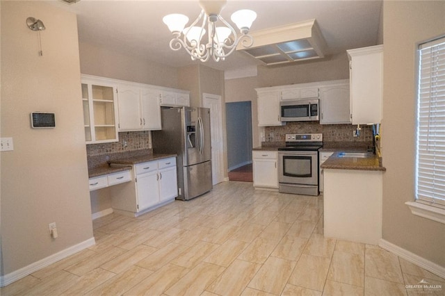 kitchen with tasteful backsplash, a chandelier, white cabinetry, sink, and stainless steel appliances