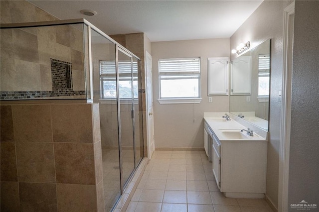 bathroom featuring a shower with door, tile patterned flooring, and vanity