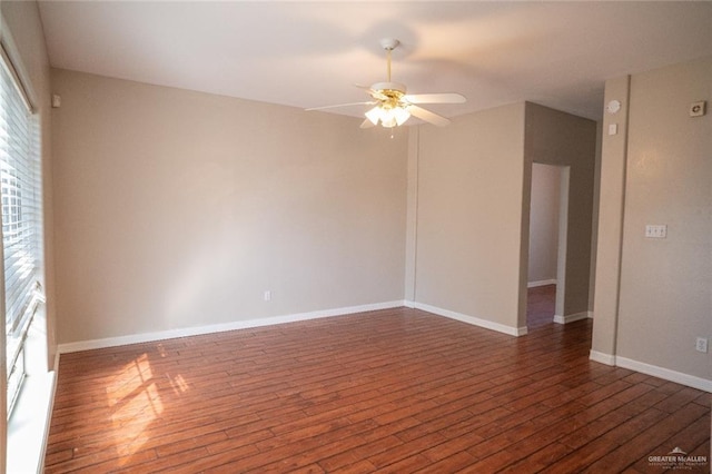 unfurnished room featuring ceiling fan and dark wood-type flooring