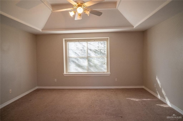 carpeted empty room with ceiling fan and a raised ceiling