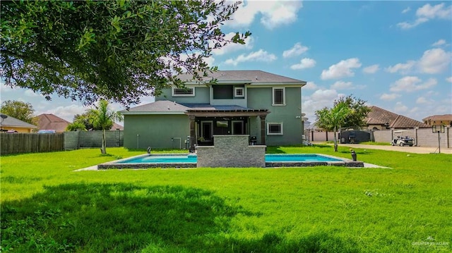 back of property featuring a fenced in pool and a yard