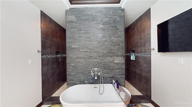 bathroom with tile walls and a tub