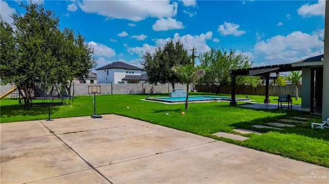 exterior space with a patio area, a yard, and a trampoline