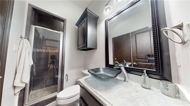 bathroom with walk in shower, vanity, and toilet