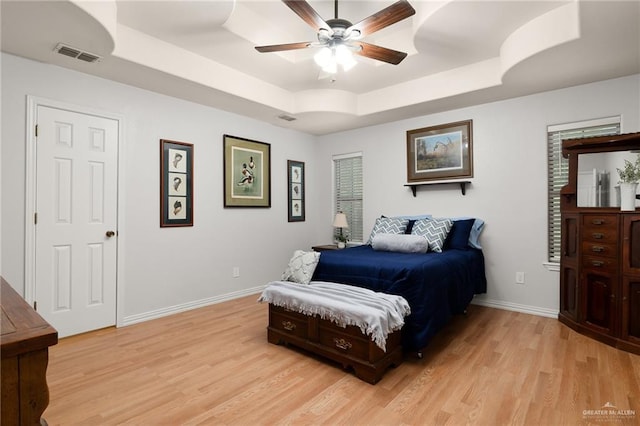 1612 W Military Hwy, Mission, TX 78572 - bedroom with light wood-style floors, ceiling fan, visible vents, a raised ceiling, and baseboards