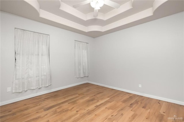 1612 W Military Hwy, Mission, TX 78572 - empty room featuring light wood-type flooring, a tray ceiling, baseboards, and ceiling fan