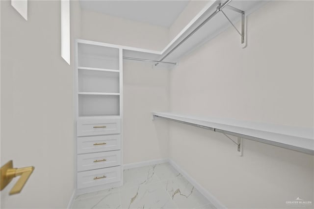 spacious closet featuring marble finish floor