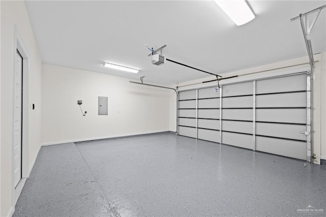 garage with electric panel, a garage door opener, and baseboards