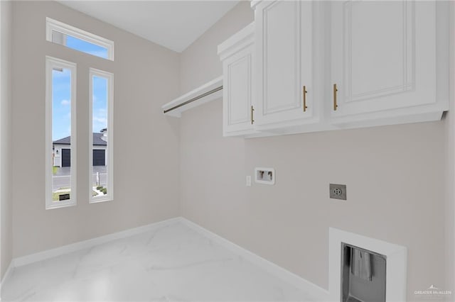 1011 Magnolia St, Mission, TX 78573 - washroom featuring hookup for an electric dryer, washer hookup, cabinet space, and marble look tiles