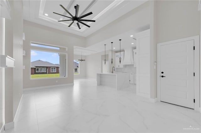 1011 Magnolia St, Mission, TX 78573 - unfurnished living room with ceiling fan, recessed lighting, a raised ceiling, and light marble finish flooring