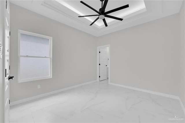 1011 Magnolia St, Mission, TX 78573 - unfurnished room with light marble finish floors, a raised ceiling, and a ceiling fan