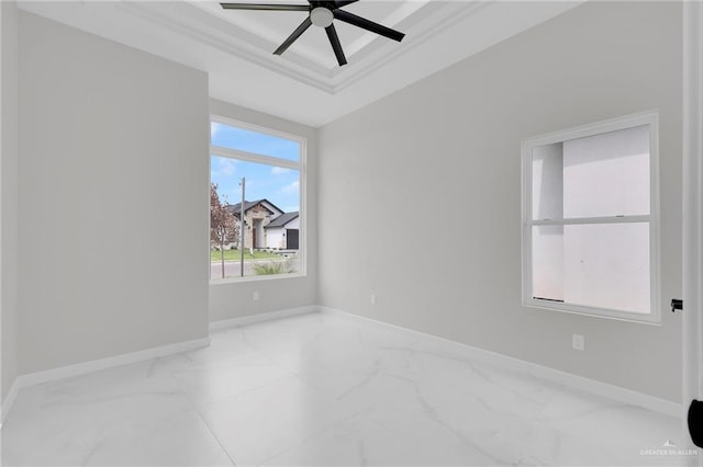 1011 Magnolia St, Mission, TX 78573 - empty room with marble look tile flooring, a tray ceiling, ceiling fan, and ornamental molding