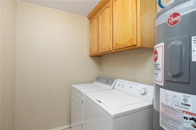 laundry room featuring cabinet space, water heater, and separate washer and dryer