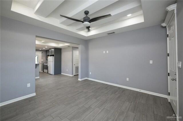 17236 Mandarin Ave, Harlingen, TX 78552 - empty room with ceiling fan, a tray ceiling, baseboards, dark wood-type flooring, and recessed lighting