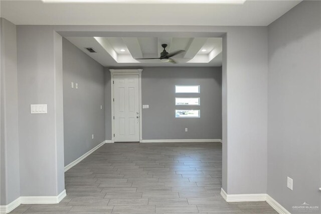 17236 Mandarin Ave, Harlingen, TX 78552 - empty room featuring a tray ceiling, wood finished floors, a ceiling fan, baseboards, and recessed lighting