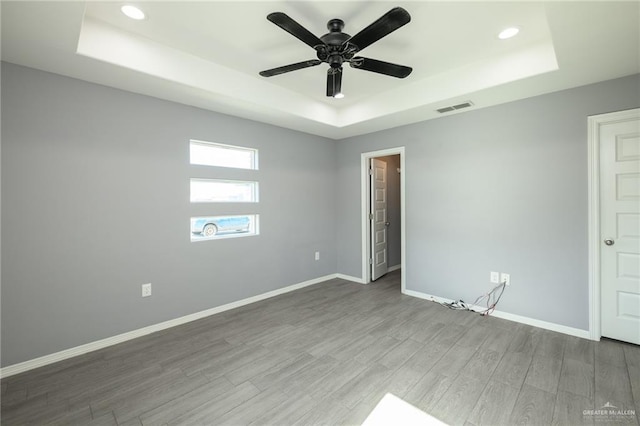 17236 Mandarin Ave, Harlingen, TX 78552 - spare room with a raised ceiling, wood finished floors, baseboards, recessed lighting, and a ceiling fan