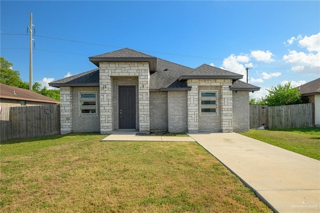 17236 Mandarin Ave, Harlingen, TX 78552 - french country home featuring a shingled roof and brick siding