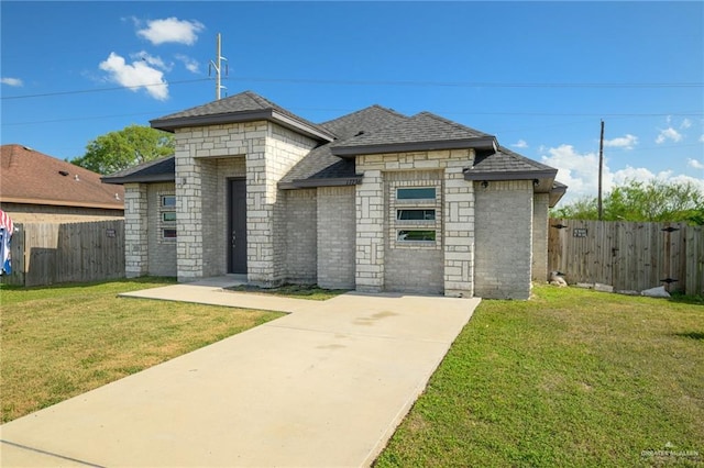 17236 Mandarin Ave, Harlingen, TX 78552 - french country inspired facade featuring a shingled roof, brick siding, concrete driveway, and stone siding