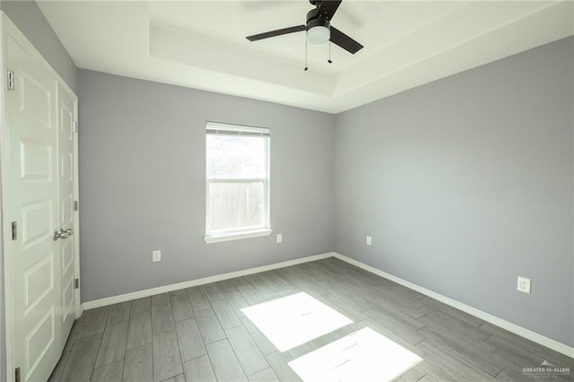 17236 Mandarin Ave, Harlingen, TX 78552 - unfurnished room featuring a raised ceiling, wood finished floors, a ceiling fan, and baseboards