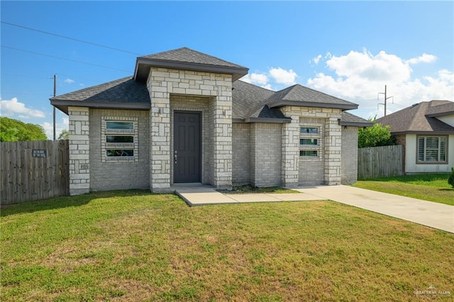 17236 Mandarin Ave, Harlingen, TX 78552 - french country inspired facade with driveway, a shingled roof, and stone siding