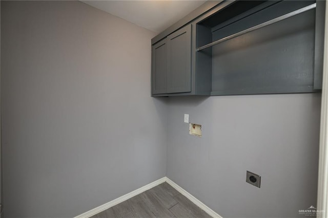 17236 Mandarin Ave, Harlingen, TX 78552 - laundry room featuring cabinet space, electric dryer hookup, baseboards, dark wood finished floors, and washer hookup