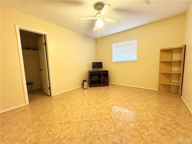 305 Redbud Ave, Mcallen, TX 78504 - unfurnished bedroom with a walk in closet, a textured ceiling, and ceiling fan