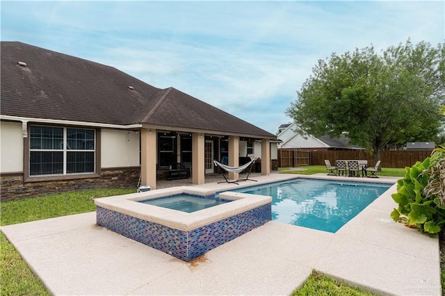 view of swimming pool with an in ground hot tub and a patio