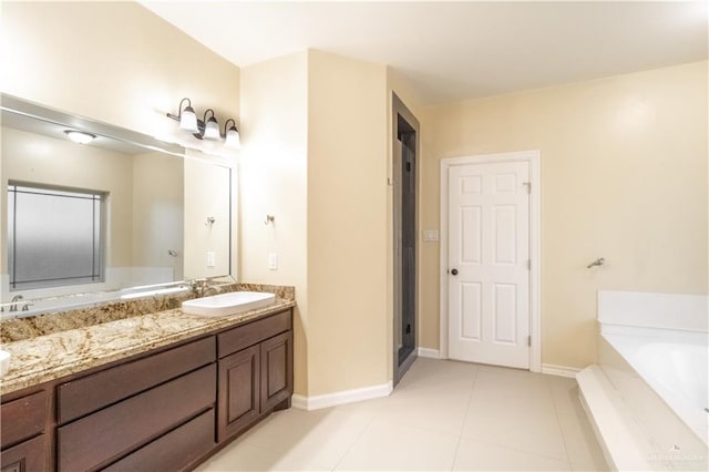 bathroom featuring tile patterned floors, vanity, and a bathing tub