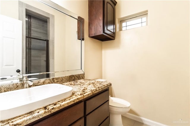 bathroom with tile patterned floors, vanity, and toilet