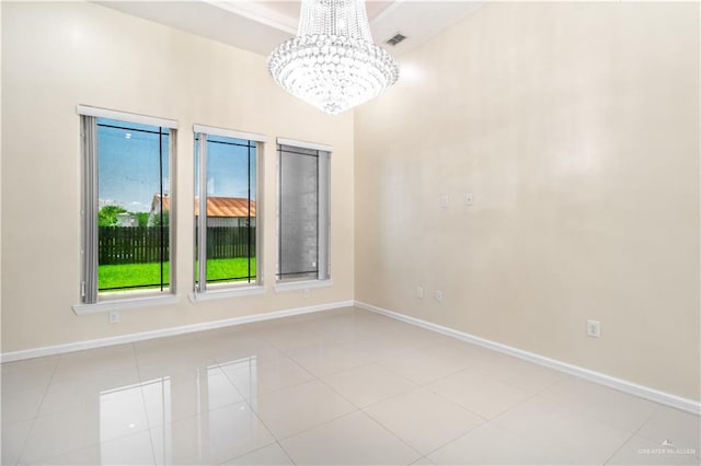 empty room featuring an inviting chandelier and light tile patterned flooring