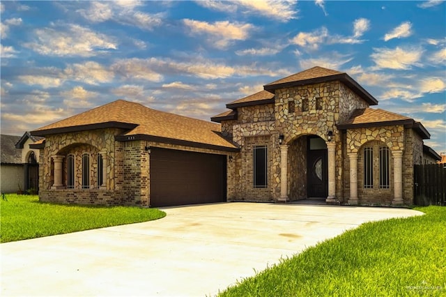 view of front of property with a garage and a front lawn