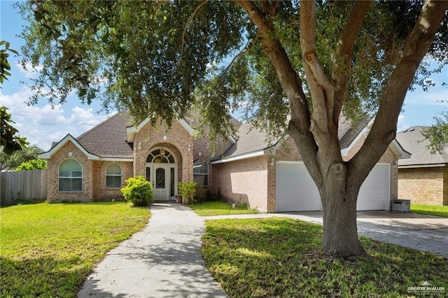 view of front of house featuring a garage and a front lawn