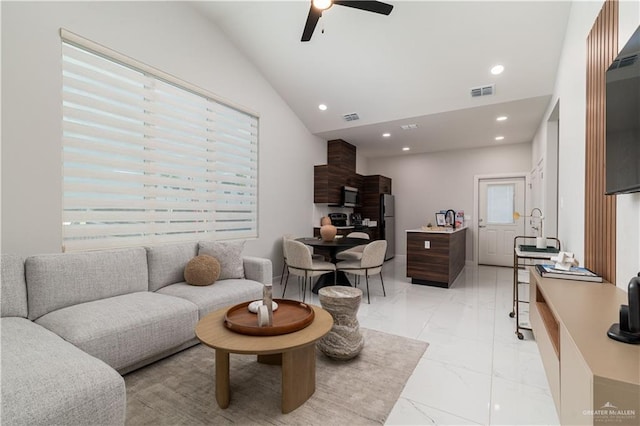 living room featuring ceiling fan and lofted ceiling