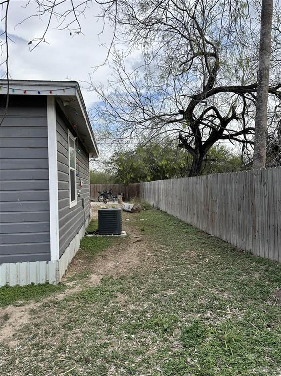 view of yard with cooling unit and a fenced backyard