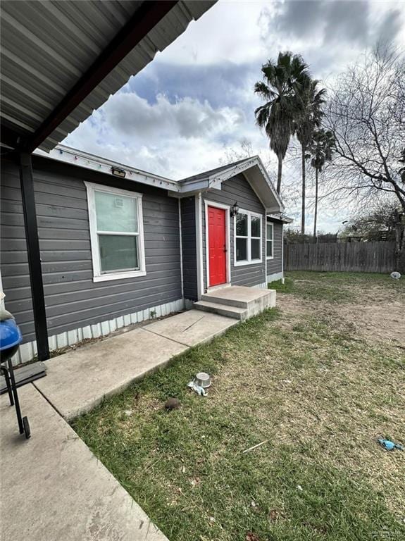 view of front of house with a front yard and fence