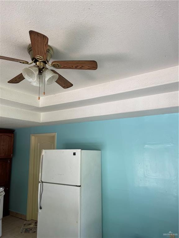 details with ceiling fan, white fridge, range, and a textured ceiling