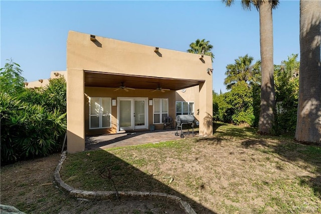 back of property featuring ceiling fan, a patio area, and french doors