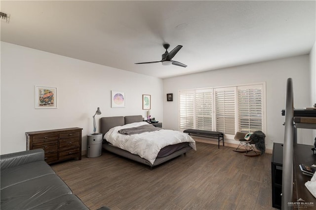 bedroom with ceiling fan and dark hardwood / wood-style flooring