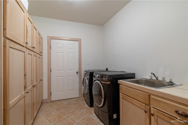 laundry room featuring sink, light tile patterned flooring, cabinets, and independent washer and dryer