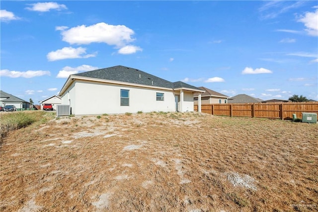 323 Santa Isabel, Rio Grande City, TX 78582 - back of property with cooling unit, fence, and stucco siding
