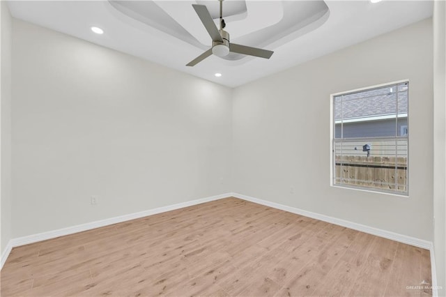 323 Santa Isabel, Rio Grande City, TX 78582 - empty room with wood finished floors, baseboards, recessed lighting, ceiling fan, and a tray ceiling