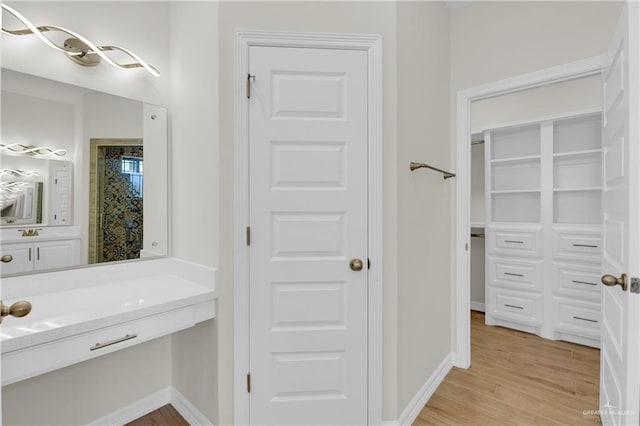 323 Santa Isabel, Rio Grande City, TX 78582 - full bathroom with wood finished floors, baseboards, and vanity