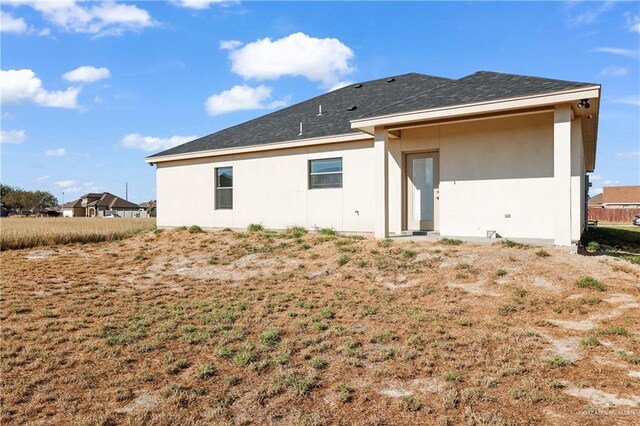 323 Santa Isabel, Rio Grande City, TX 78582 - back of house featuring stucco siding