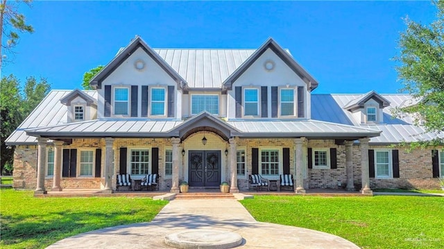 9325 W Mile 8 Rd, Mission, TX 78573 - view of front of property with a standing seam roof, covered porch, metal roof, and brick siding