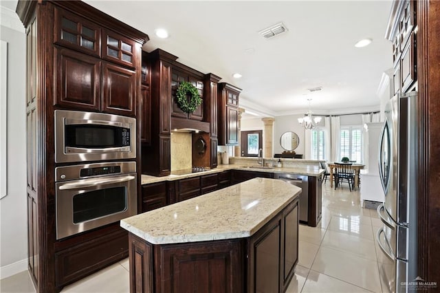 9325 W Mile 8 Rd, Mission, TX 78573 - kitchen with appliances with stainless steel finishes, a peninsula, a sink, a chandelier, and pendant lighting