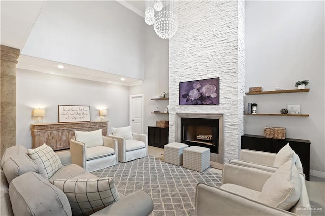 9325 W Mile 8 Rd, Mission, TX 78573 - living room featuring a high ceiling, a chandelier, a stone fireplace, baseboards, and recessed lighting