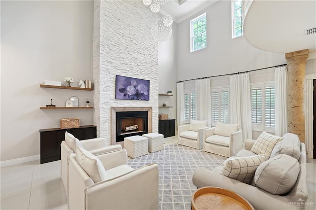 9325 W Mile 8 Rd, Mission, TX 78573 - living area featuring a high ceiling, a chandelier, baseboards, and a stone fireplace