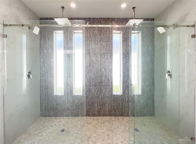 bathroom featuring a shower with door